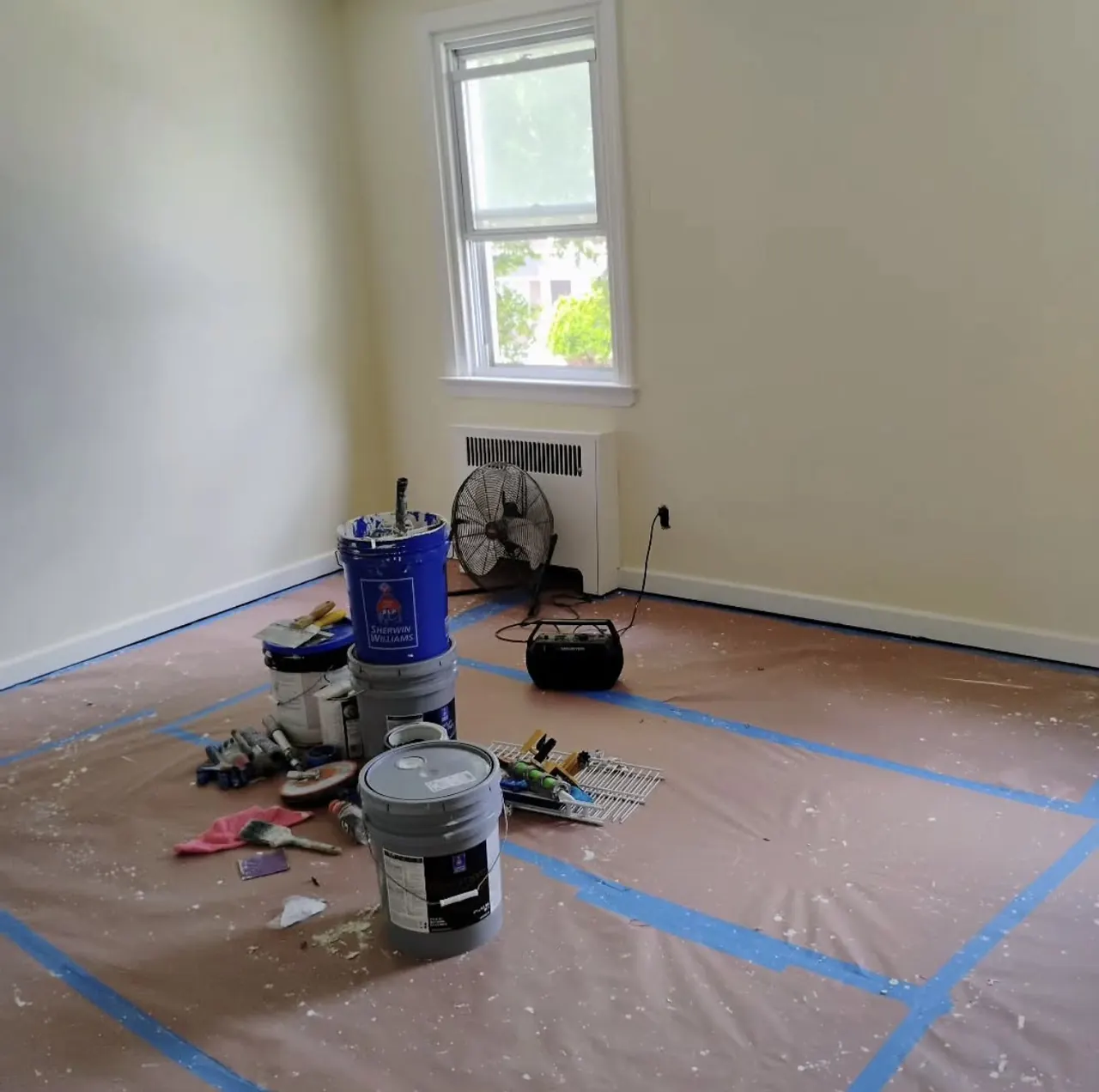 Room with floors masked and covered before painting